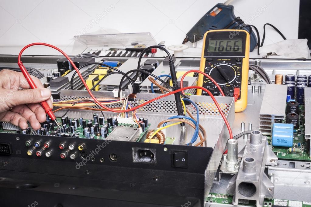 Electronics engineer probing a circuit board