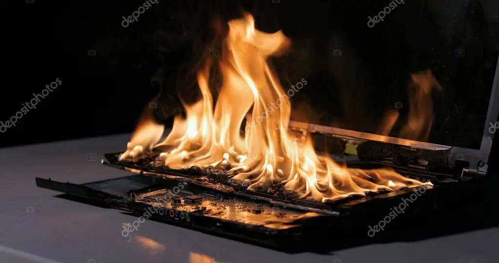 Technician cleaning laptop cooling fan