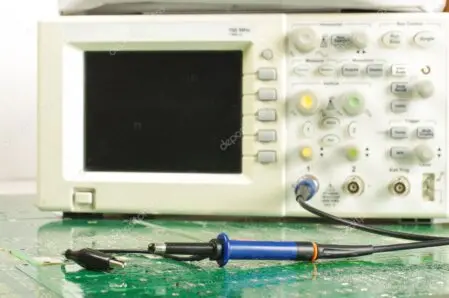 Electronics lab bench with oscilloscope and programmable load
